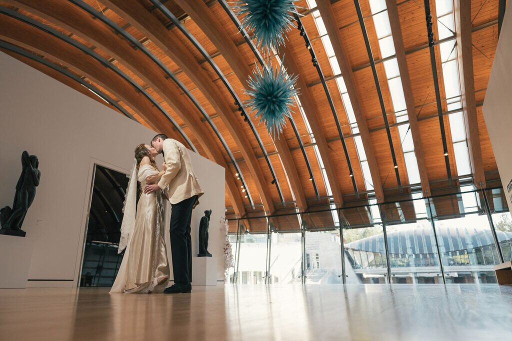 Newlyweds kiss at Crystal Bridges Museum wedding venue in NW Arkansas