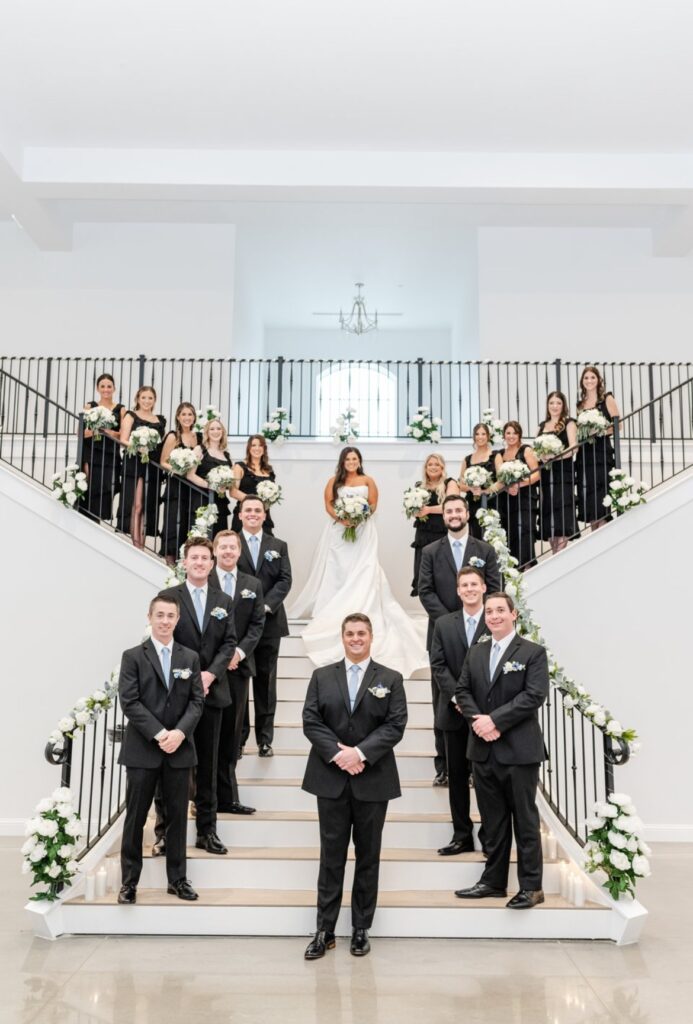 Wedding party on grand staircase at Arkansas wedding venue
